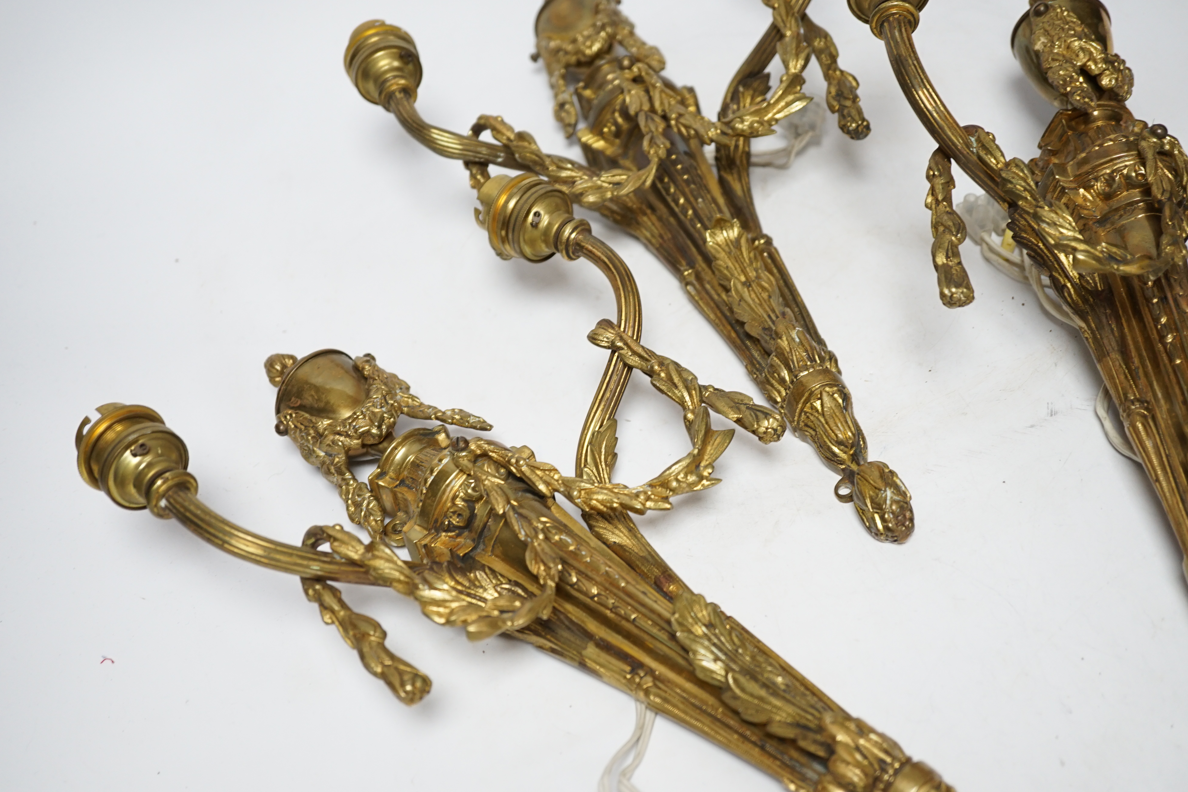 A set of three Louis XVI style two branch ormolu wall lights, 38cm high
